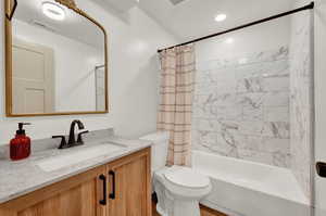 Full bath featuring shower / bath combination with curtain, vanity, and recessed lighting