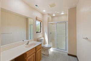 Full bath with vanity, a stall shower, and light wood-type flooring