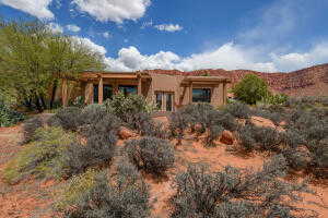 Back of property featuring stucco siding
