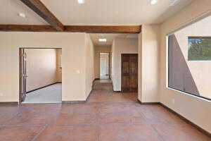 Empty room featuring recessed lighting and beamed ceiling