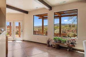 Unfurnished dining area with finished concrete flooring and beam ceiling
