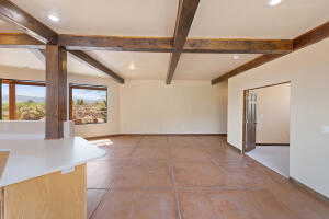 Unfurnished room with beamed ceiling, concrete flooring, and recessed lighting