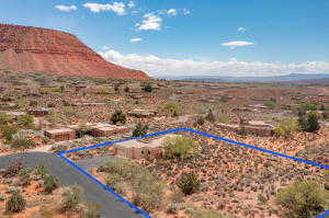 Overview of rural landscape with property parcel outlined and a mountainous background