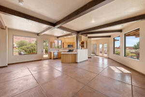 Kitchen with beam ceiling, open floor plan, and french doors