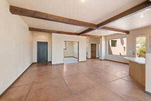 Spare room with beam ceiling, light tile patterned floors, and recessed lighting