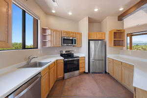 Kitchen featuring open shelves, light countertops, appliances with stainless steel finishes, recessed lighting, and dark tile patterned floors