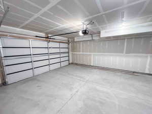 Garage featuring a garage door opener