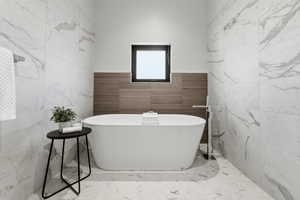 Bathroom with tile walls and a freestanding tub
