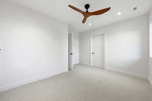 Unfurnished room featuring light carpet, ceiling fan, and recessed lighting