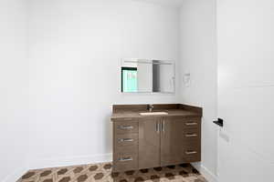 Bathroom featuring vanity and light flooring