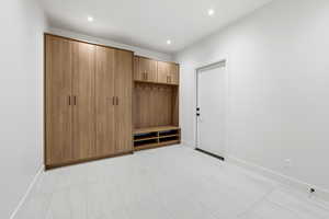 Mudroom with baseboards and recessed lighting
