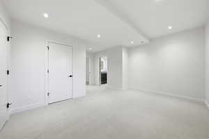 Spare room featuring light colored carpet and recessed lighting