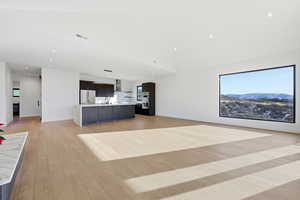 Unfurnished living room featuring light wood finished floors and recessed lighting