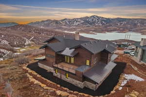 Aerial view of property and surrounding area with a mountainous background