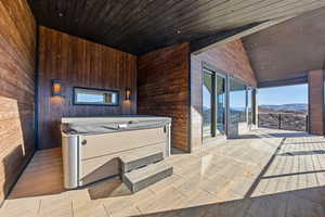 Kitchen featuring wood ceiling, wooden walls, a mountain view, and wood finish floors