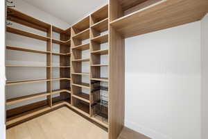 Walk in closet featuring light wood-type flooring