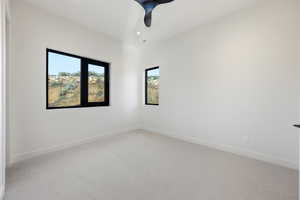 Empty room featuring light colored carpet, recessed lighting, and a ceiling fan