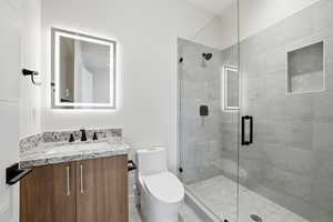 Full bath featuring vanity and a stall shower