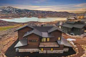 Aerial view of property and surrounding area with a water and mountain view