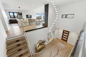 Interior space featuring wood finished floors, recessed lighting, and a high ceiling