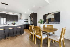 Dining space with light wood-style floors and baseboards