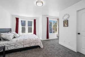 Carpeted bedroom featuring baseboards