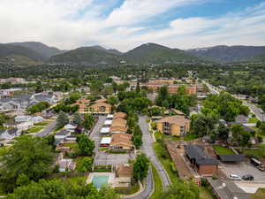 Aerial overview of property's location with mountains and nearby suburban area