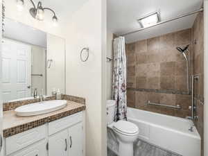 Full bath featuring shower / bath combination with curtain and vanity