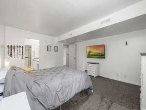 Bedroom featuring carpet and ensuite bath