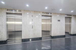 Building  high speed elevators in the lobby with recessed lighting