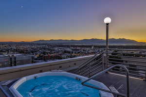 View of hot tub with a mountain view and a city view