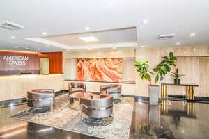 Building lobby featuring recessed lighting and wood walls