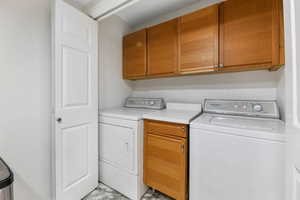Laundry room with washing machine and clothes dryer and cabinet space