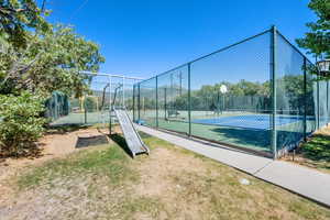 View of tennis court with community basketball court