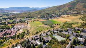 Aerial view of property's location featuring nearby suburban area and a mountain backdrop