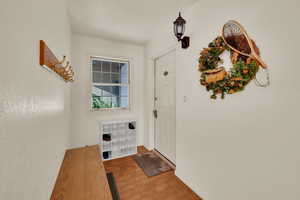 Entryway with tile patterned floors and baseboards