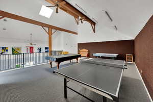 Recreation room with ceiling fan, billiards, beam ceiling, high vaulted ceiling, and carpet flooring