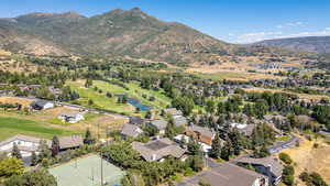 Aerial perspective of suburban area featuring a water and mountain view and a local golf course