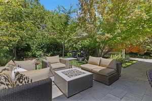 View of patio featuring an outdoor living space with a fire pit