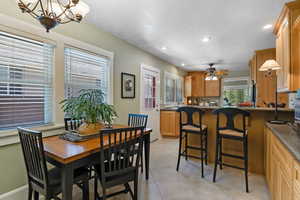 Dining room with recessed lighting, light tile patterned floors, ceiling fan, and a textured ceiling