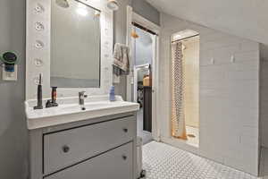 Bathroom featuring vanity, curtained shower, and tile patterned floors