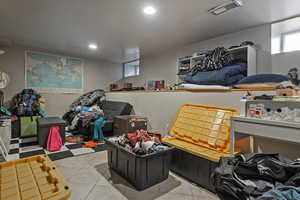 Playroom featuring light tile patterned flooring and recessed lighting