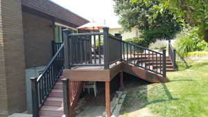 Deck featuring stairs and a lawn