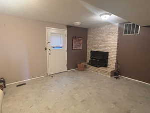 Below grade area featuring a textured ceiling and wooden walls