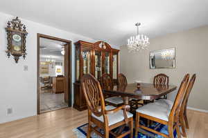 Dining room with a chandelier and light wood-type flooring
