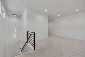 Unfurnished room featuring recessed lighting and light colored carpet
