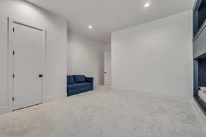 Unfurnished room with light carpet and recessed lighting