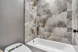 Full bath with toilet and shower / bath combination