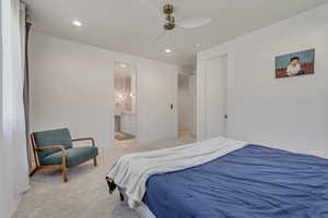 Bedroom with recessed lighting, light carpet, a ceiling fan, and ensuite bathroom