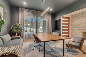 Office area with wood finished floors and recessed lighting
